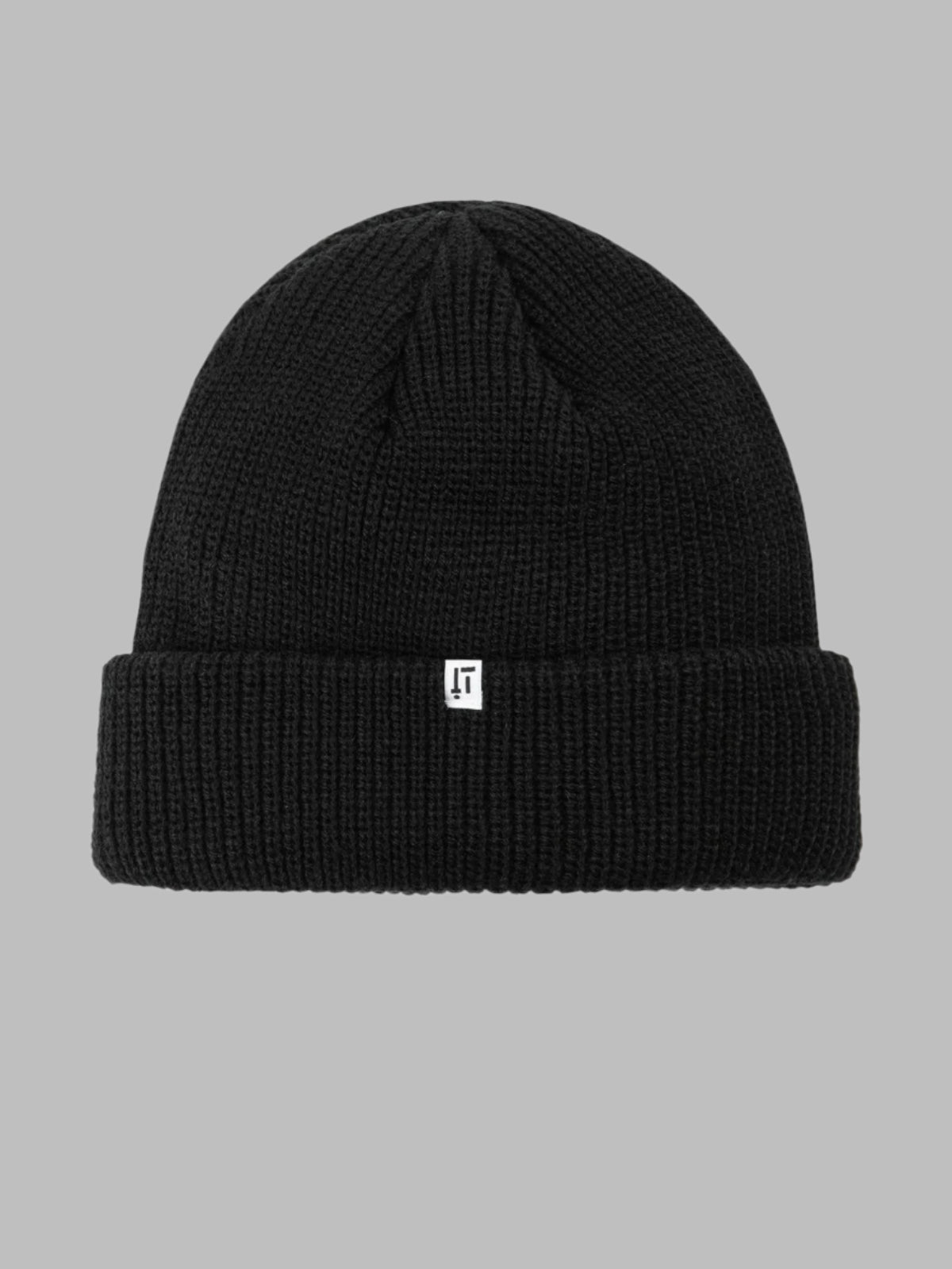 Black beanie with a small white logo on a gray background