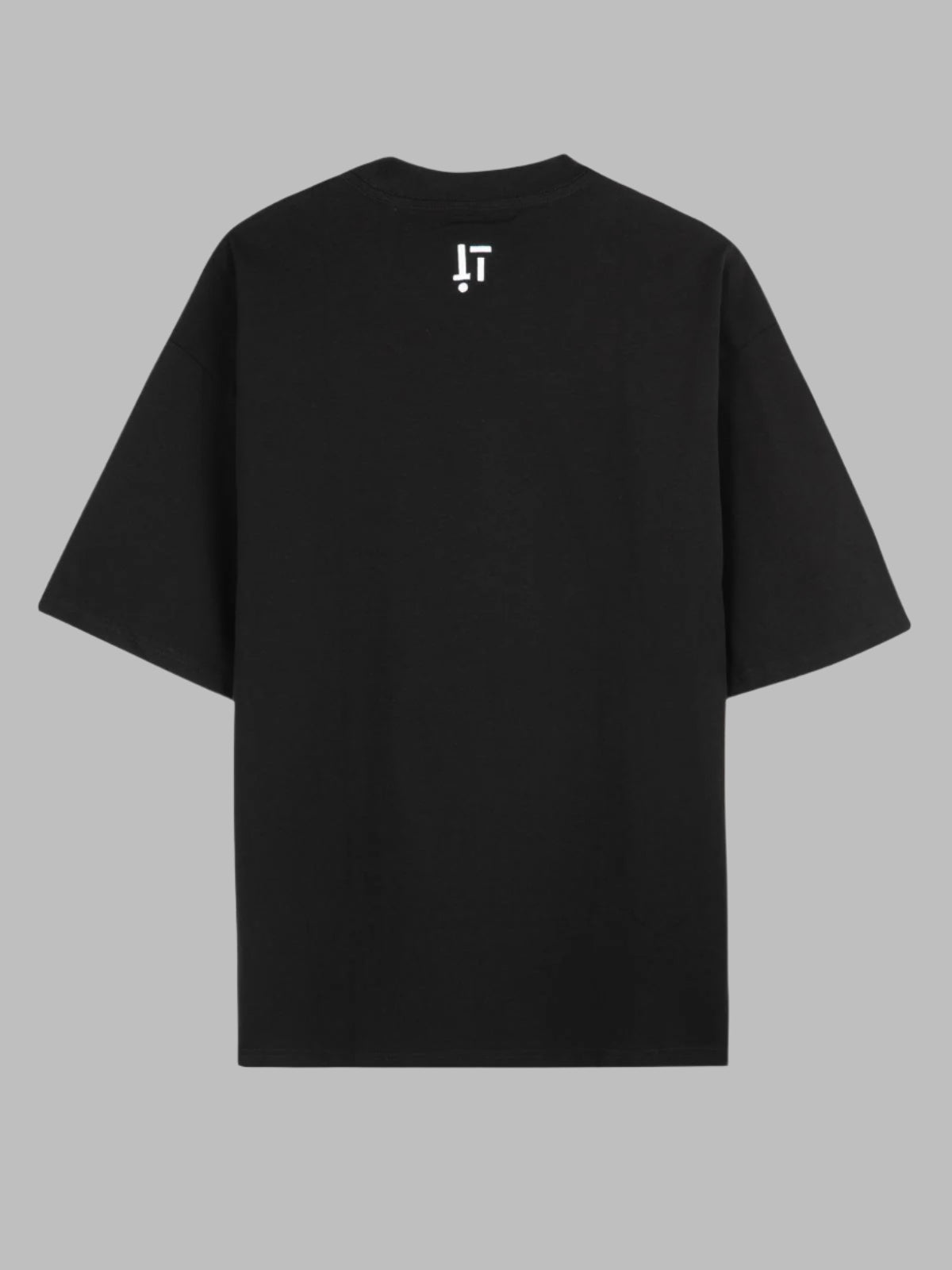 Black t-shirt with a small white logo on the back against a gray background