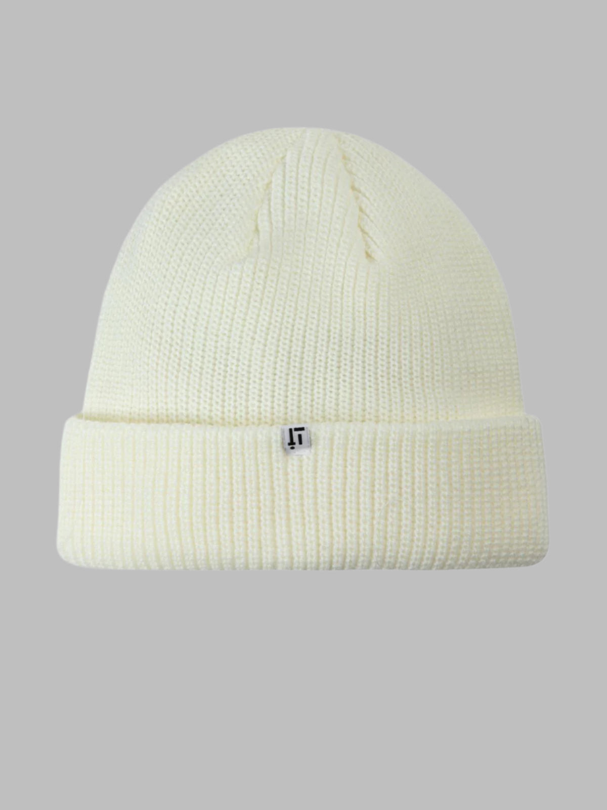 Cream-colored beanie with a small logo on a gray background
